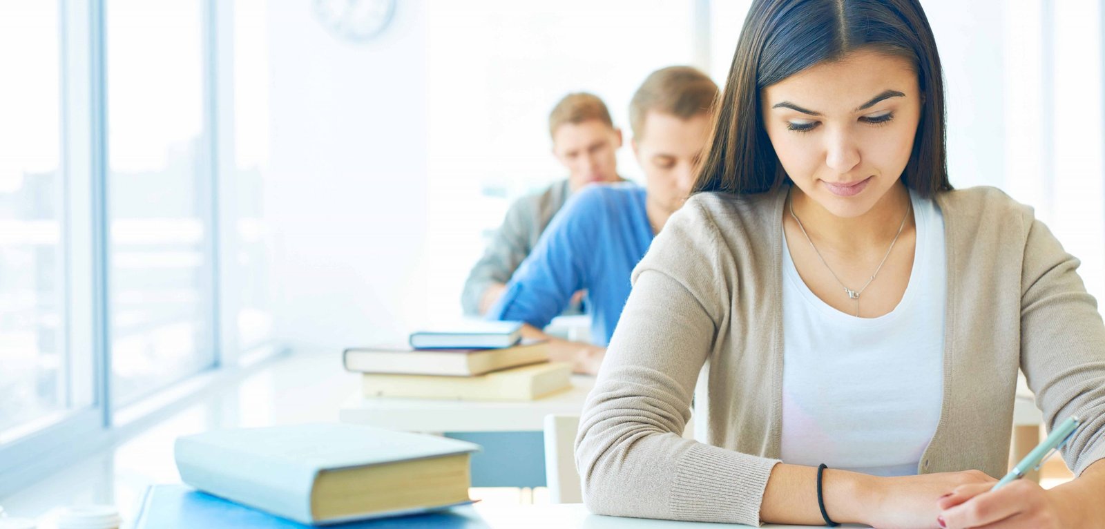 Portrait of pensive student carrying out test at lesson